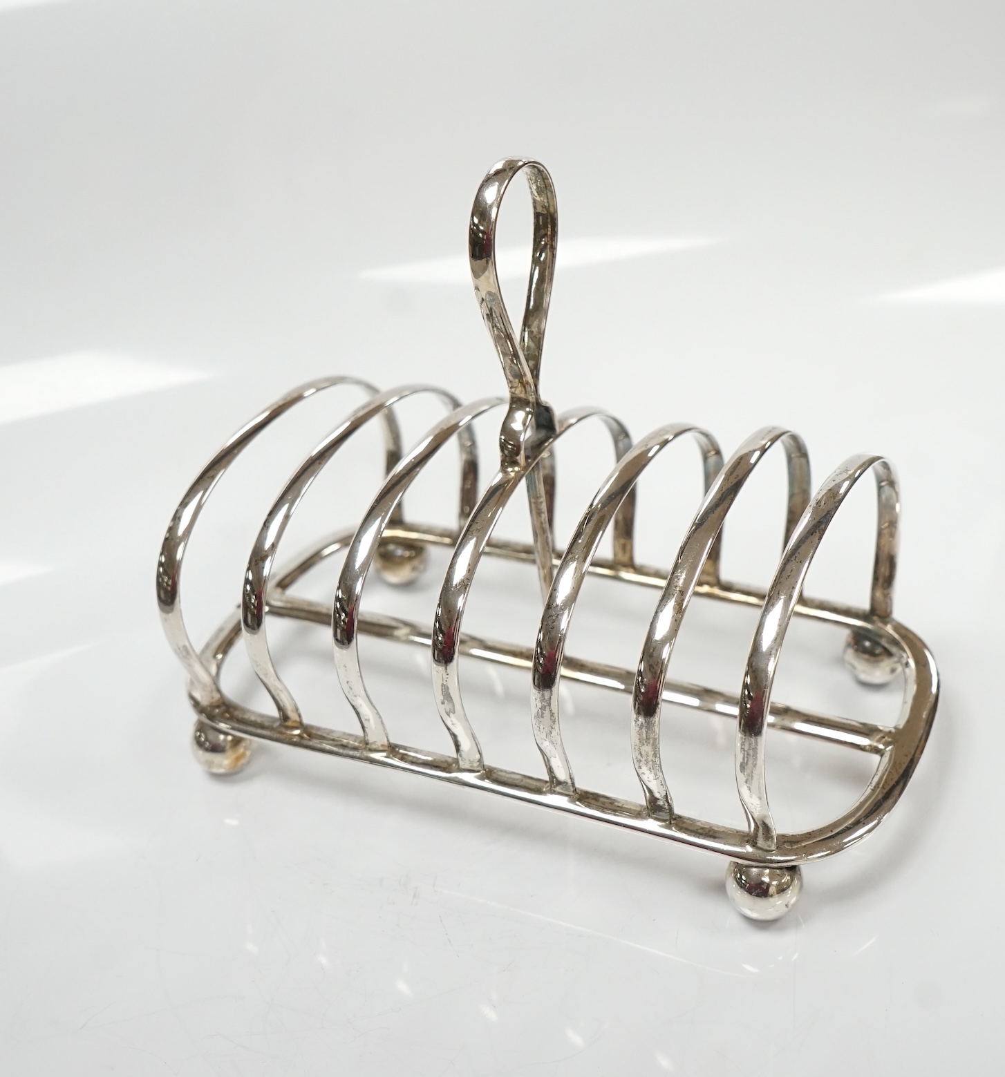 A George V silver seven bar toast rack, by Mappin & Webb, Sheffield, 1913, length 15cm, 7.3oz. Condition - fair to good